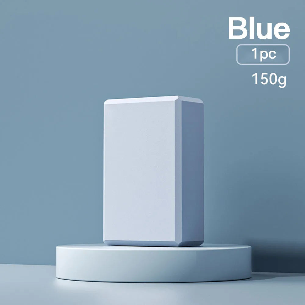Blue EVA foam yoga block on a yoga mat, showing 23x15x7.6cm dimensions and textured surface for grip