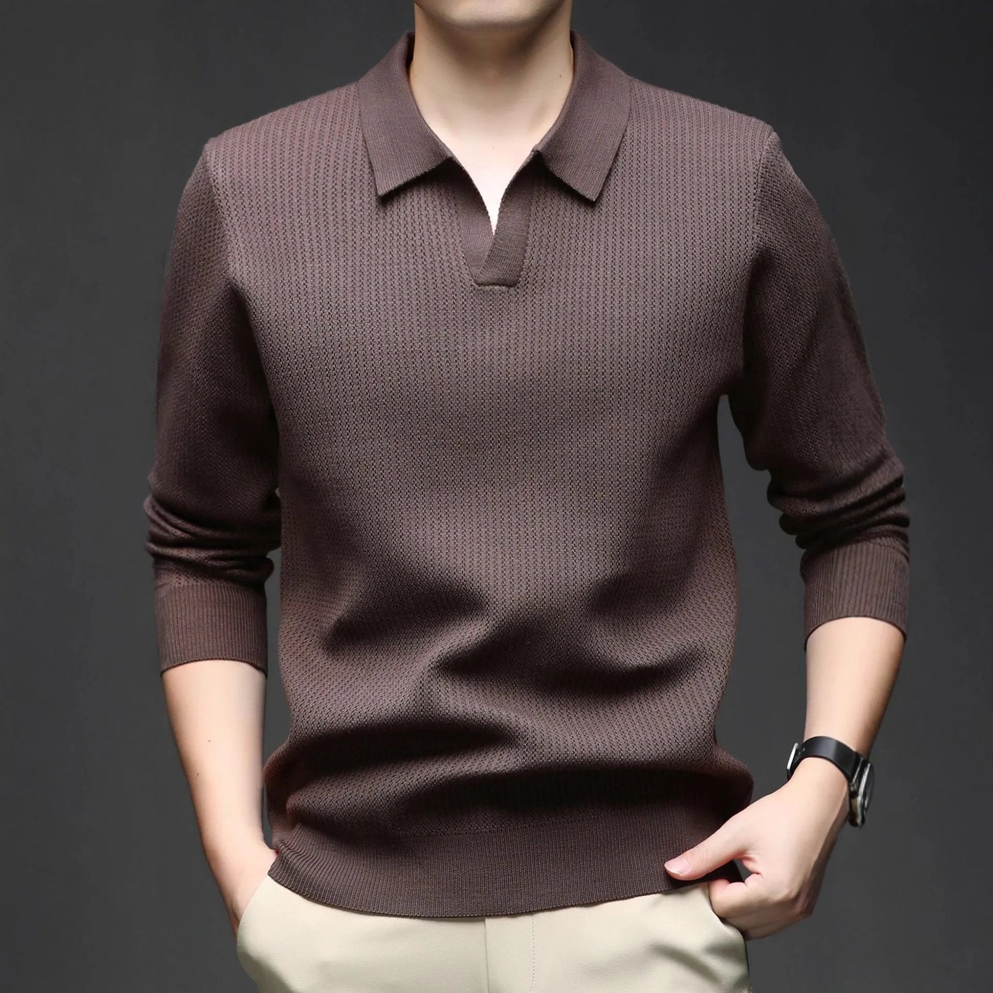 Man wearing a loose fit camel coloured pullover sweater, a casual autumn layer with a simple design.