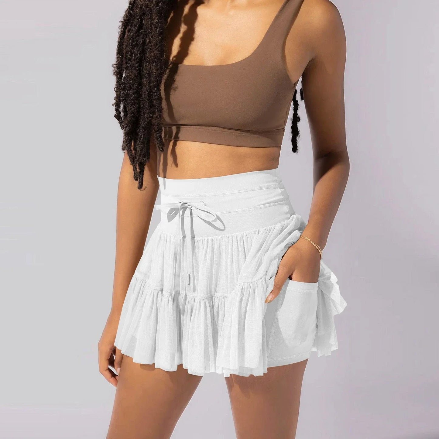 Stylish high-waist pleated mini skirt with lace-up design and built-in anti-exposure safety shorts, available in a variety of vibrant colors.