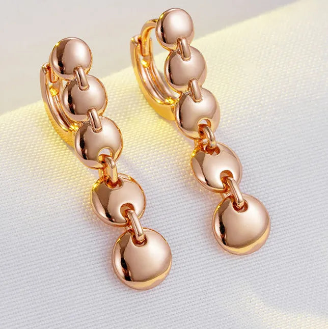 Gold finish hand-woven copper circle earrings showing textured surface and 5cm diameter