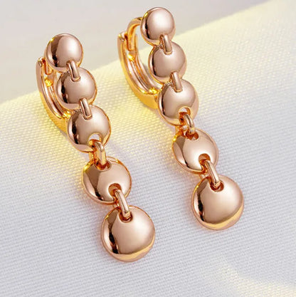 Gold finish hand-woven copper circle earrings showing textured surface and 5cm diameter