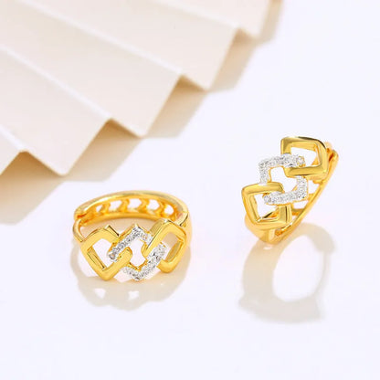 Gold geometric hollow-out alloy stud earrings on a plain background.