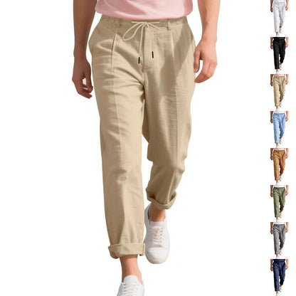 Men's light beige linen trousers with a loose straight leg and drawstring waist on a hanger.