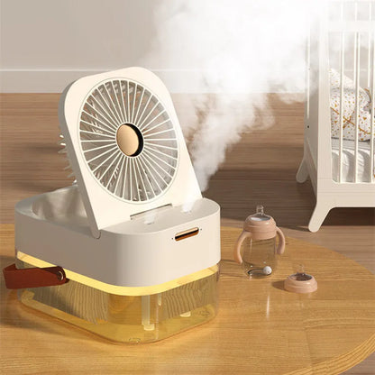 White or green USB desktop mist fan with large water tank, remote control, and dual spray nozzles on a desk.