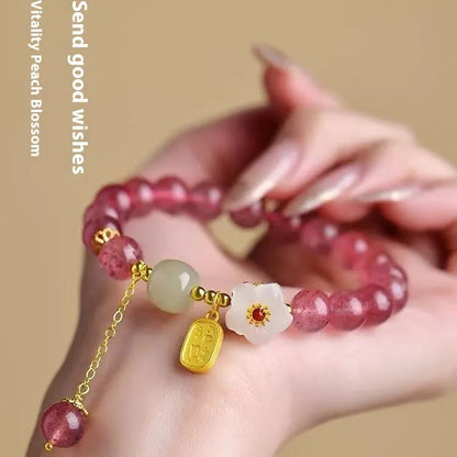 Handcrafted strawberry quartz crystal bracelet with adjustable string closure and Hetian jade peach blossom design