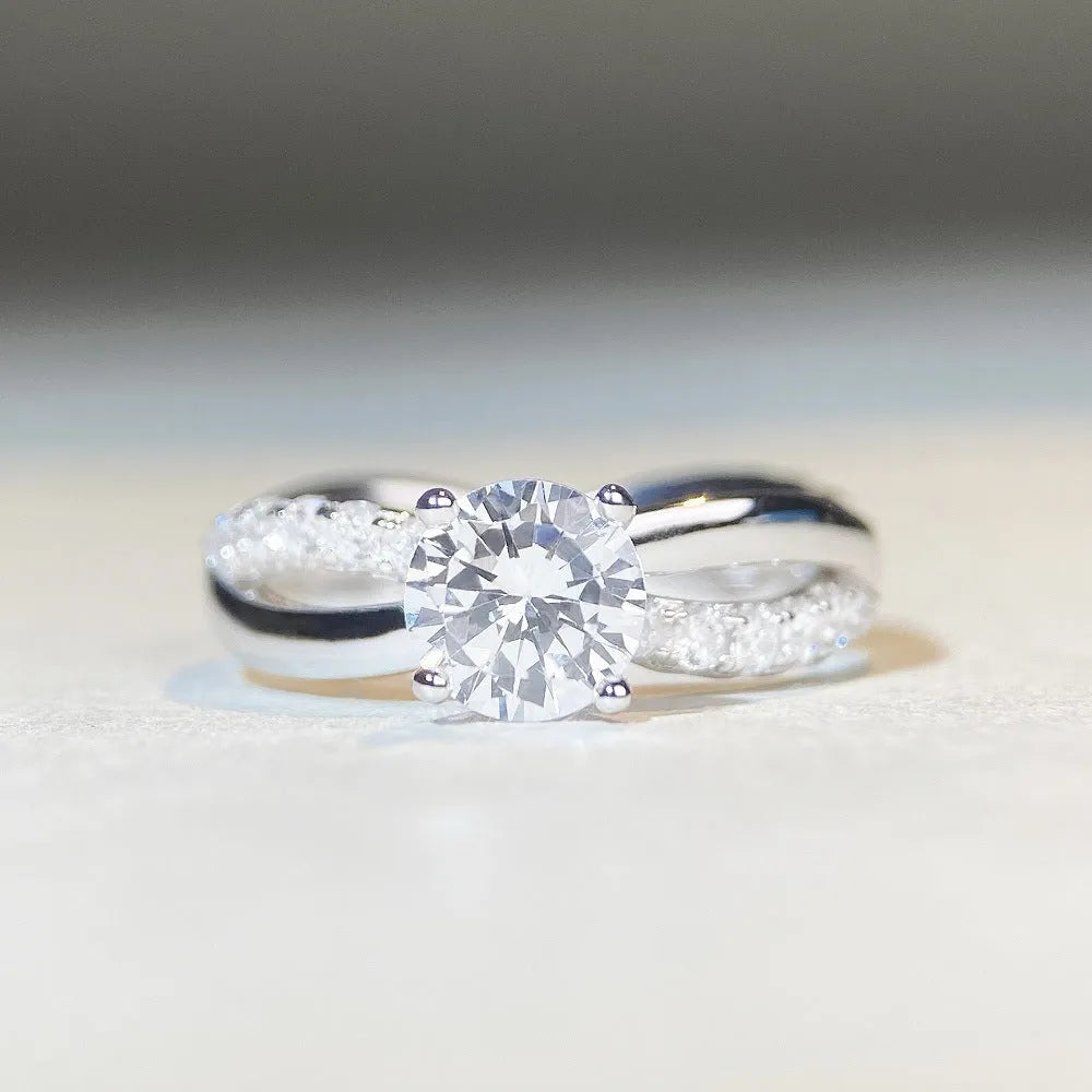 Geometric silver ring with 1 karat moissanite centre stone in four-claw setting and twisted arm band design