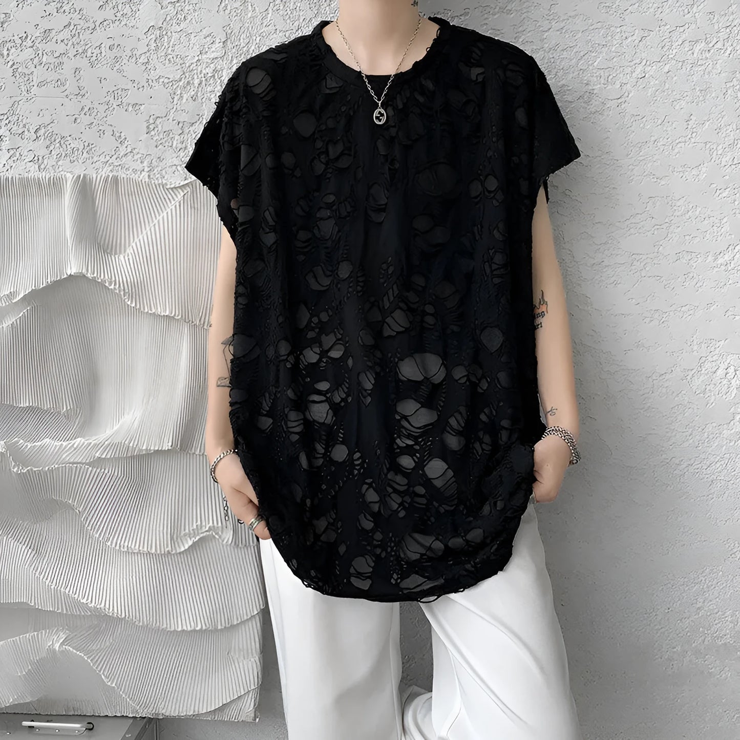 Black sleeveless vest with distressed hole detailing and wide shoulder loose fit