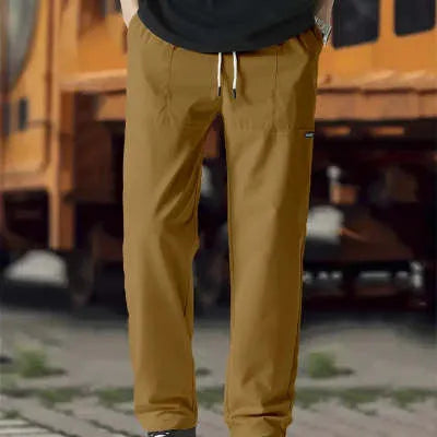 Men's polyester trousers for spring and autumn in light grey, shown in a casual setting
