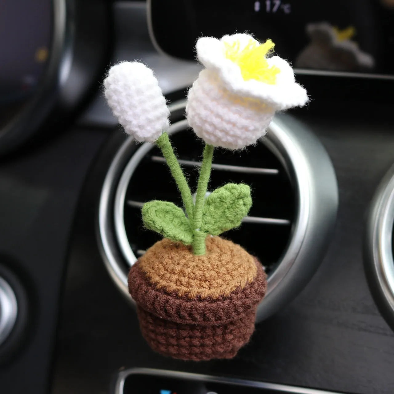 Creative wool potted plant car air vent clip aromatherapy pendant on a car vent.