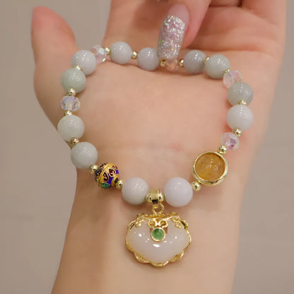 Geometric ethnic style jade bracelet for women with metal charm decoration in gray or strawberry quartz.