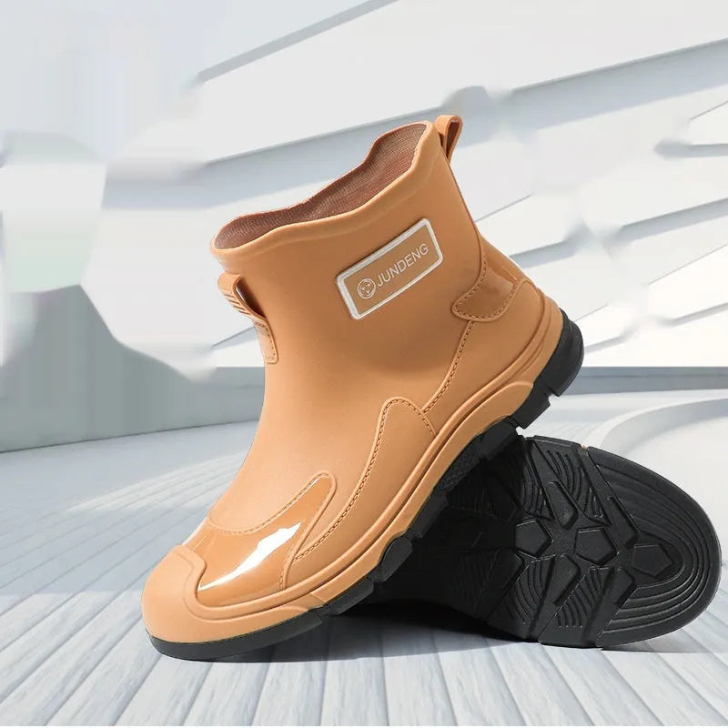 Women's short tube PVC waterproof boots in black with a round toe and flat plastic sole.