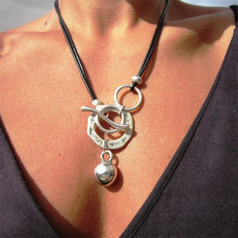 Stylish leather necklace with a boho-chic buckle detail, perfect for adding a touch of rustic charm to any outfit.