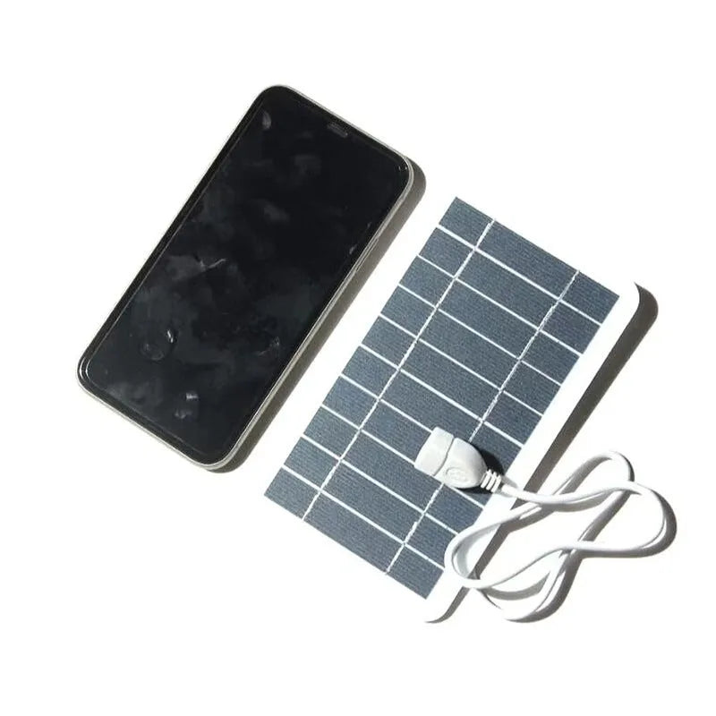 Portable solar panel charger with 2W 5V output and USB connection for charging mobile phones, fans, flashlights, and monitoring devices, measuring 157 x 94mm with a 50cm cable