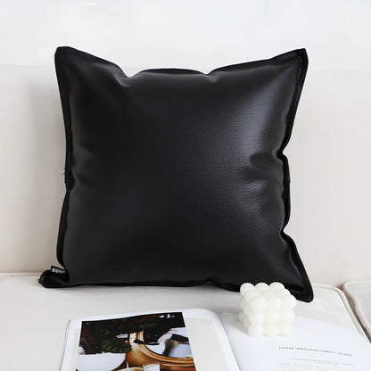 Black and white checkerboard square pillow measuring 45cm on sofa