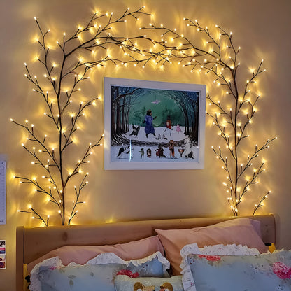 Flexible DIY willow vine LED light garland with warm white lights shaped on a wall.