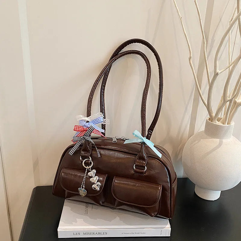 Retro brown PU leather women's pillow bag with a double shoulder strap and flap closure.