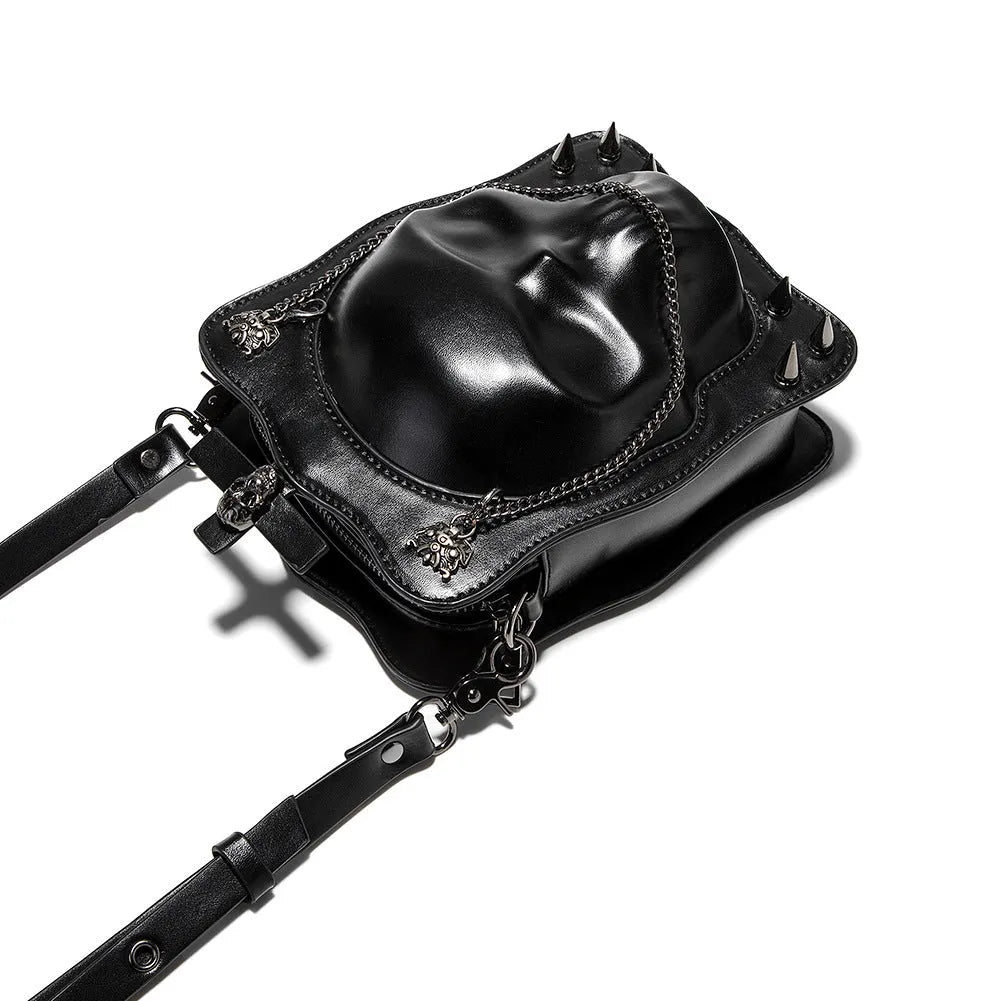 Black mini square messenger bag with embossed skull design, metal chains, and crossbody strap