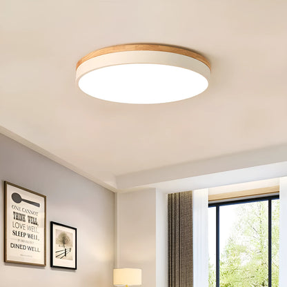 Round solid wood and acrylic LED ceiling lamp with dimming control in a modern living room setting.
