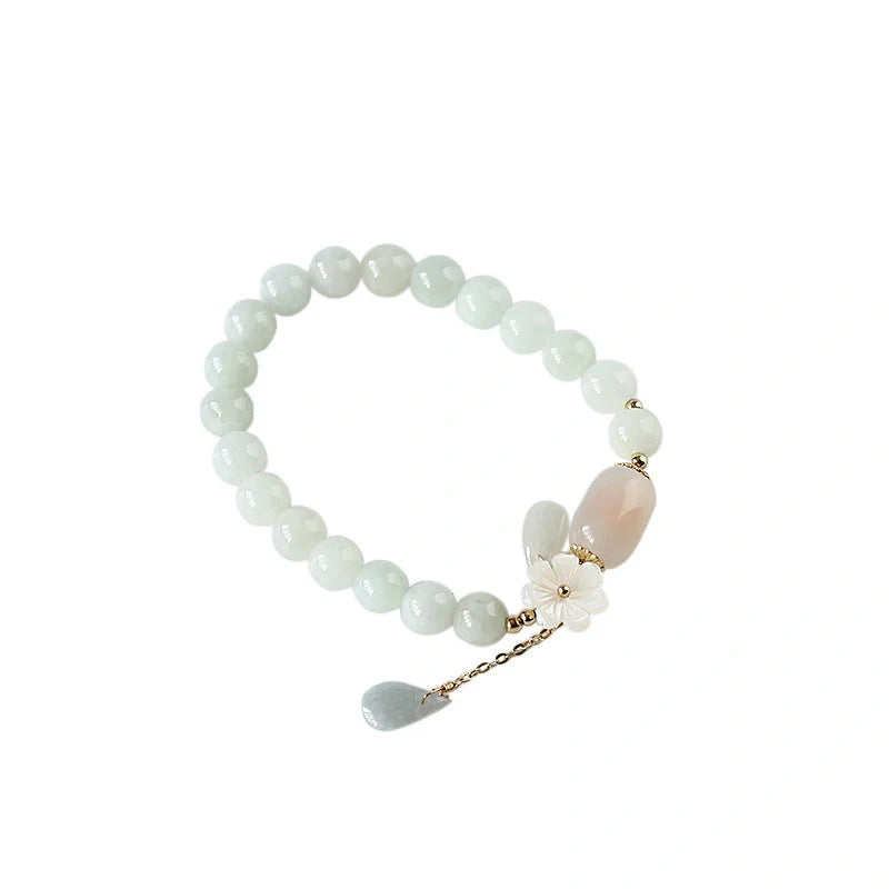 Elegant jade and shell bracelet with geometric design, featuring natural jadeite, apple agate, and genuine shells accented by 14K gold fittings