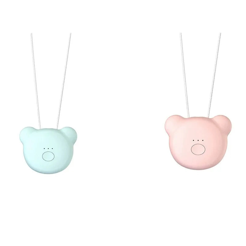 Pink wearable USB air purifier necklace on a table with USB cable, showing compact size.