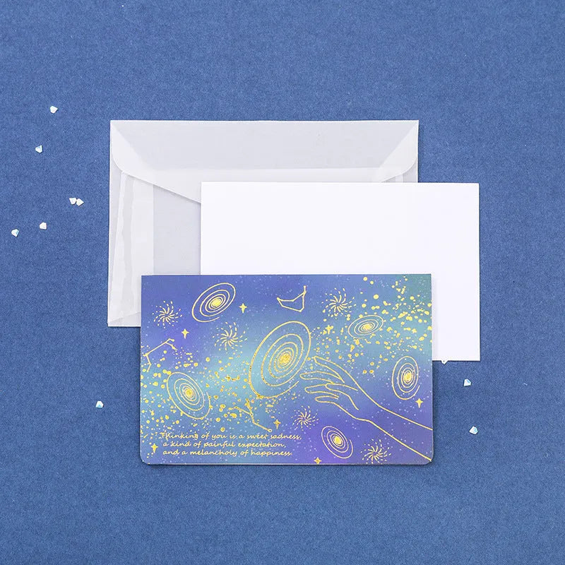 Set of three bronzing detail greeting card envelopes in cosmic colours, showing mermaid style fold.
