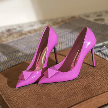 Women's pink pointed toe stiletto high heels with buckle closure and patent leather upper