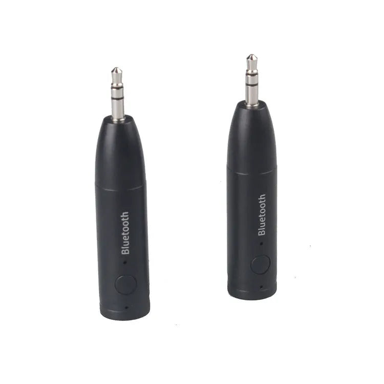 Compact black Bluetooth audio receiver with 3.5mm jack for car stereo and USB cable.