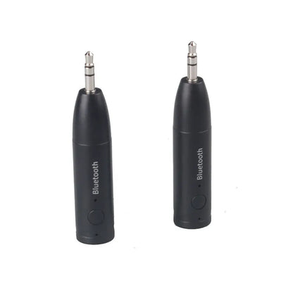 Compact black Bluetooth audio receiver with 3.5mm jack for car stereo and USB cable.