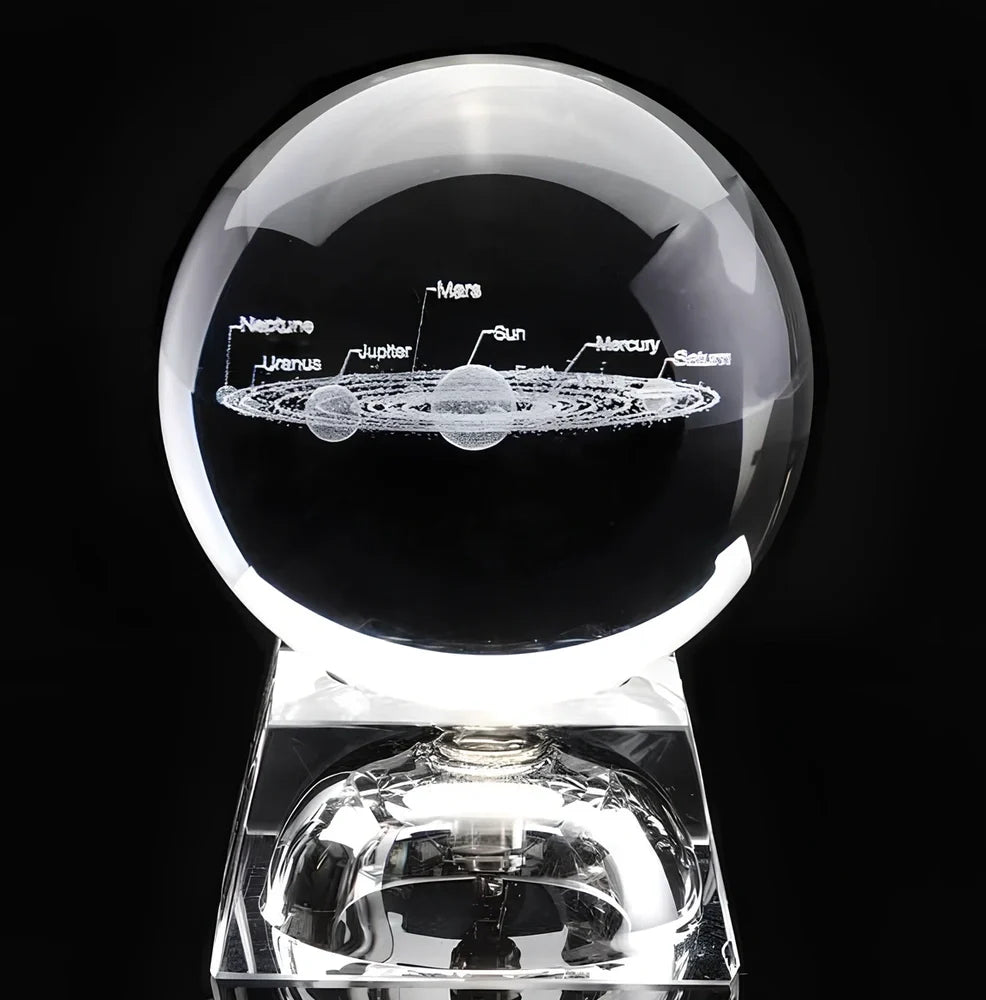 Solar system crystal ball showing planets inside K9 optical crystal sphere on metallic base