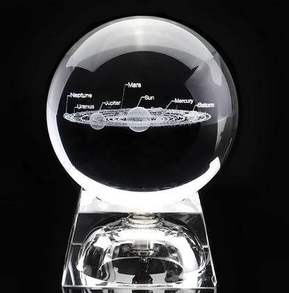 Solar system crystal ball showing planets inside K9 optical crystal sphere on metallic base