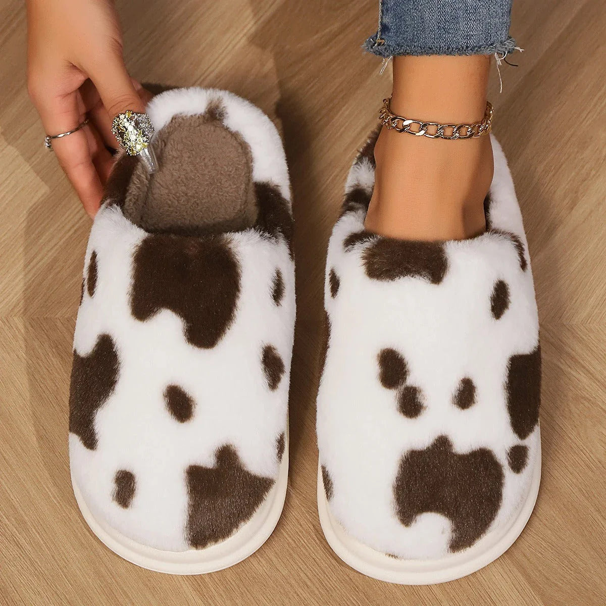 Cozy plush cow-print slippers with non-slip soles for comfortable indoor wear