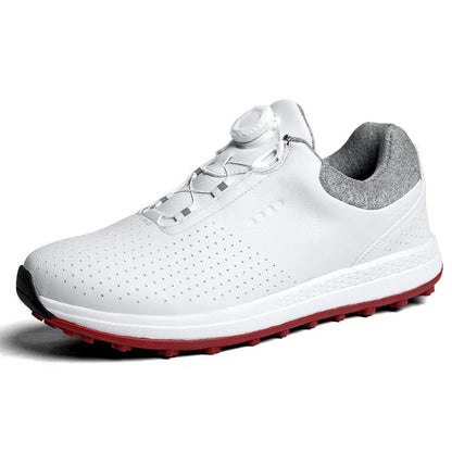 Men's white and black casual golf shoes with perforated upper and low-top design on a grass surface.