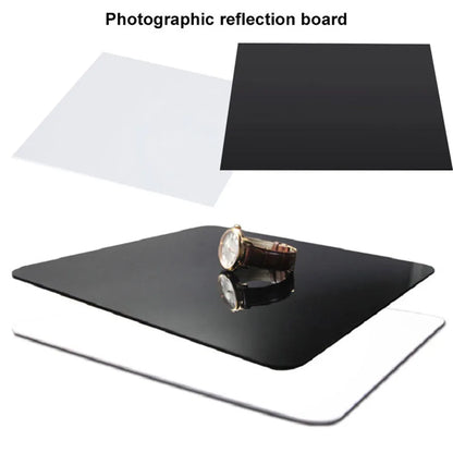 Square black and white acrylic reflection boards for product photography on a table