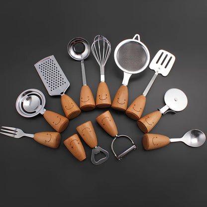 Twelve-piece stainless steel kitchen tools with beech handles and smiley motifs on a kitchen counter