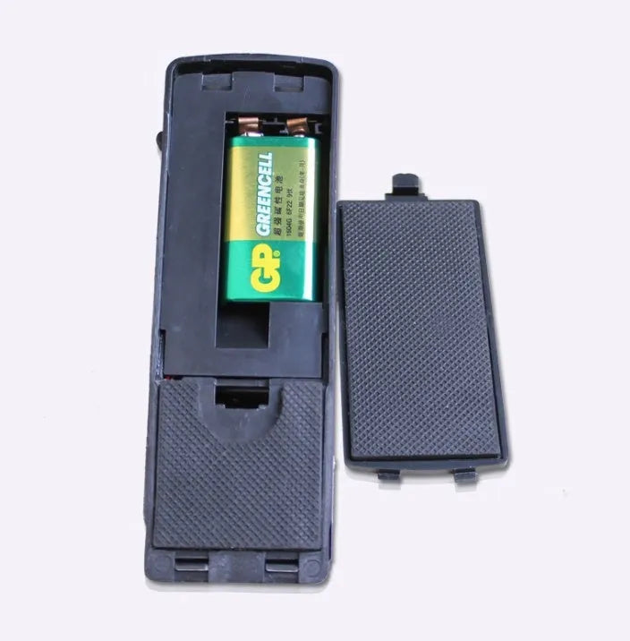 Portable wedge-shaped door stop alarm unit with stainless steel cover and sensitivity controls.