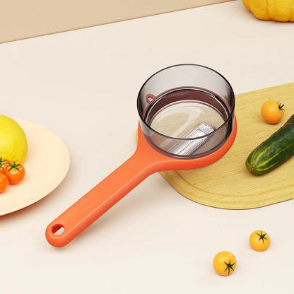 Light green kitchen peeler with an integrated storage bucket for collecting fruit and vegetable peel.