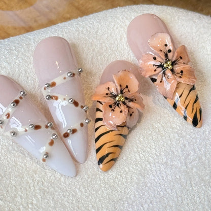 Set of ten leopard print, cross, and floral design press-on nail stickers in long-tip style on a white background.