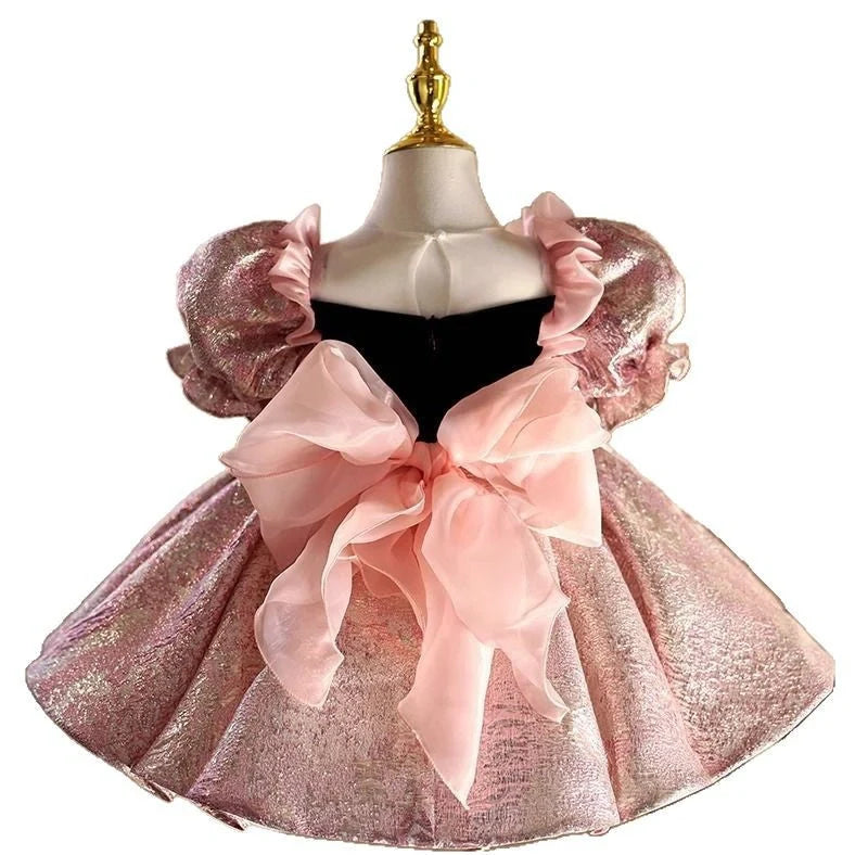 Pink children's princess dress with cute design elements, shown on hanger