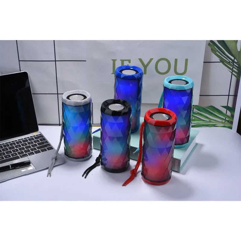 Portable Bluetooth speaker with dual 5W drivers, LED light, available in blue, green, grey and red.
