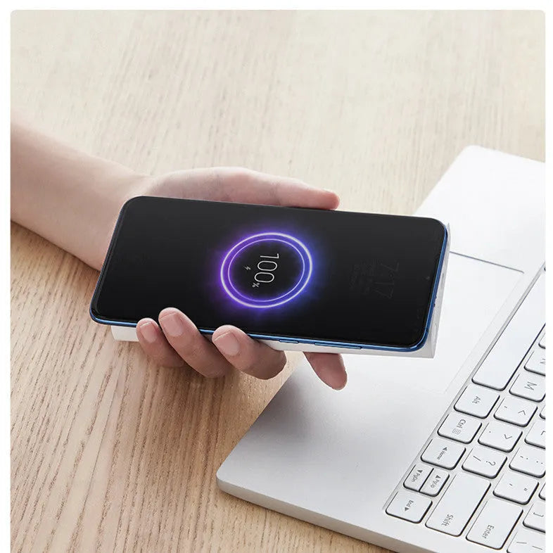 Black or white 10000mAh power bank with USB Type-C input and wireless charging surface
