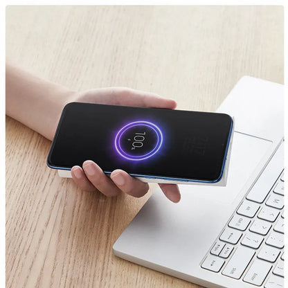 Black or white 10000mAh power bank with USB Type-C input and wireless charging surface
