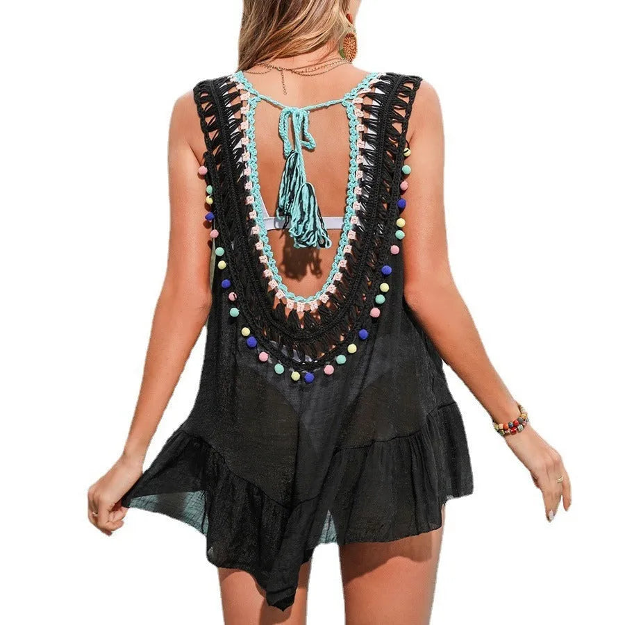 Black hand-crocheted women's beach cover-up with a cut-out design and ruffled trim.