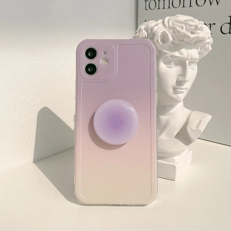 Yellow to purple gradient silicone iPhone case with a pop-out kickstand deployed.