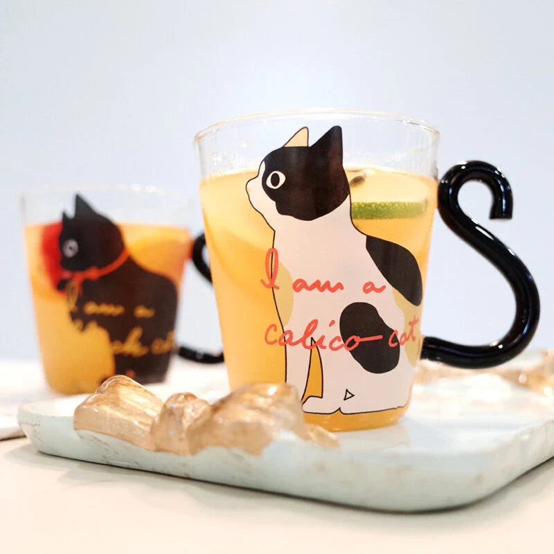Adorable cat-shaped glass mug in black and white colors, perfect for coffee, tea, or juice
