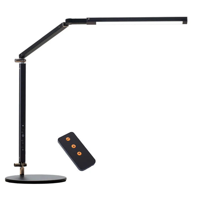 Clip-on adjustable arm LED desk lamp in black mounted on a desk edge with remote control.