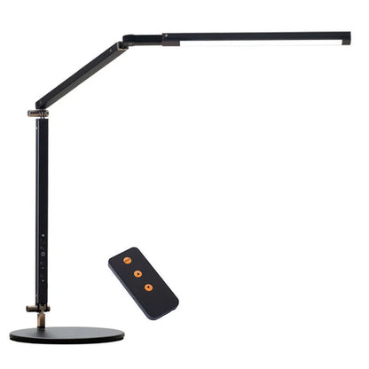 Clip-on adjustable arm LED desk lamp in black mounted on a desk edge with remote control.