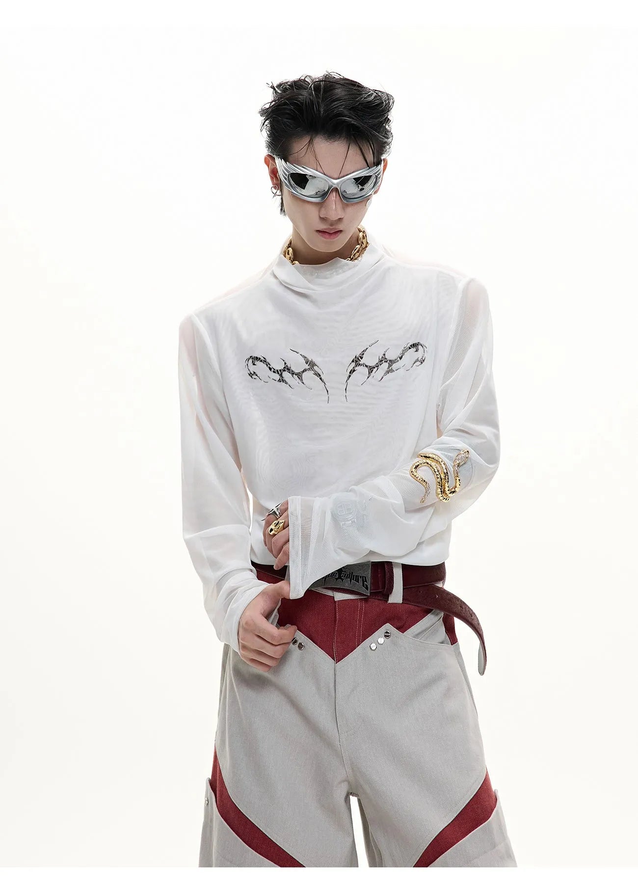 Man wearing a black slim-fit niche mesh long sleeve base layer shirt.