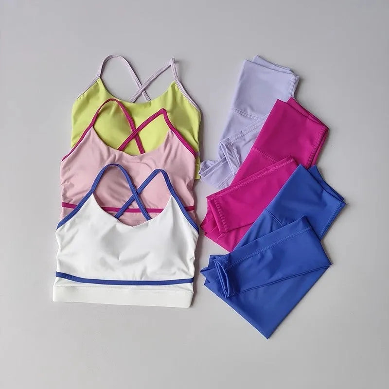 Women's blue and white nylon spandex yoga set with sleeveless tank top and cropped pants.