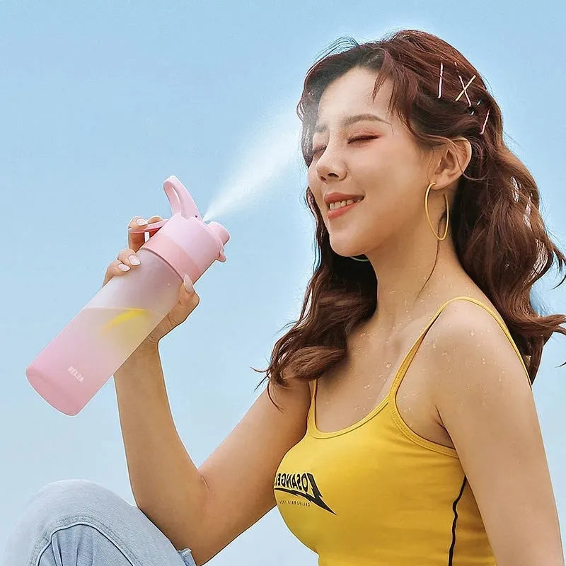 Large plastic spray water bottle with handle strap and leakproof lid in green colour.