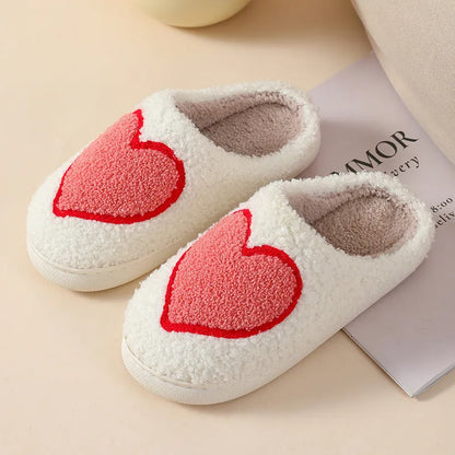 Women's plush home slippers in cartoon designs with a non-slip PVC sole.
